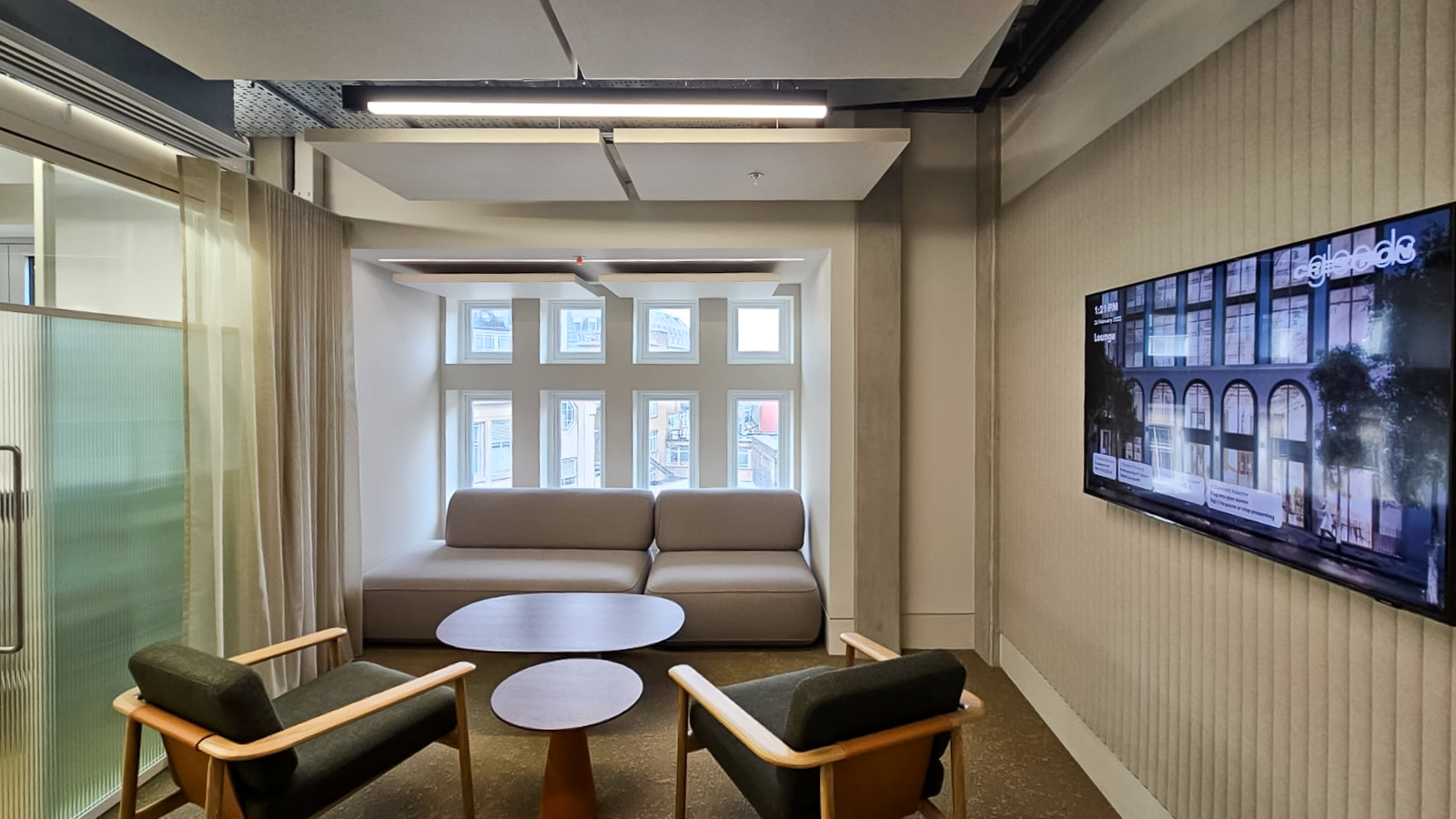 Open plan office meeting room with acoustic panels on the ceiling